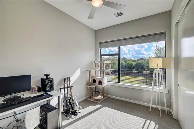 a kitchen island with granite countertop a sink and living room view