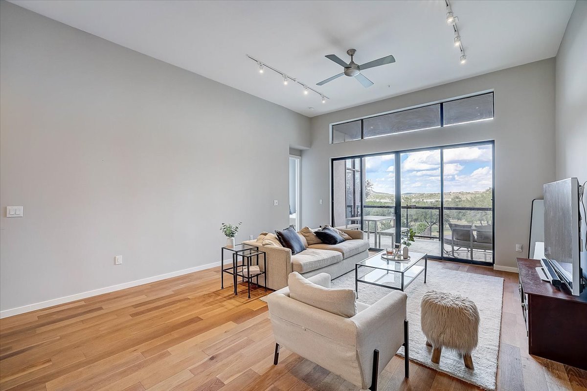 5921 Hiline Road, Unit 1204 Austin, TX 78734 - Photo 8 of 36 Living room with track lighting, light wood-type flooring, and a ceiling fan