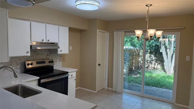 a kitchen with sink a refrigerator and stove