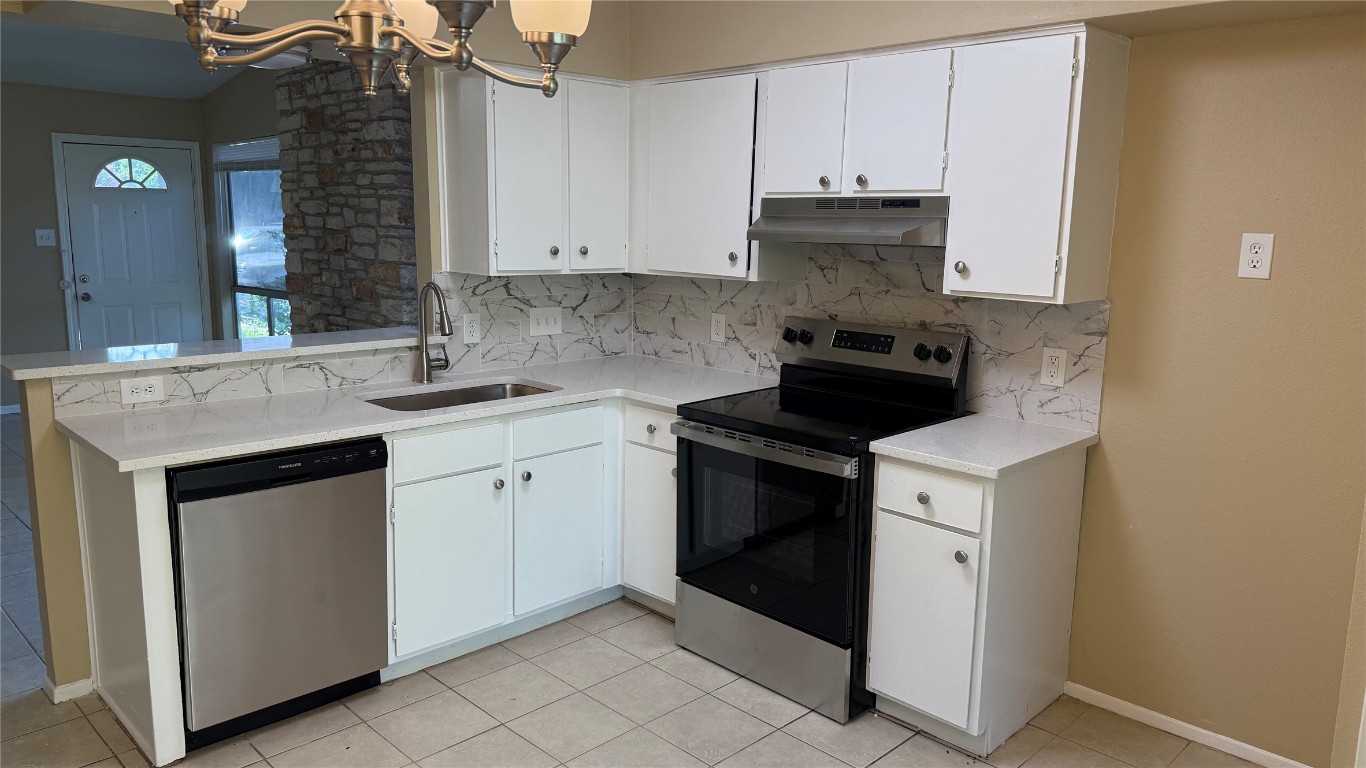 10400 Burmaster Lane, Unit A Austin, TX 78750 - Photo 3 of 20 a kitchen with white cabinets and a stove
