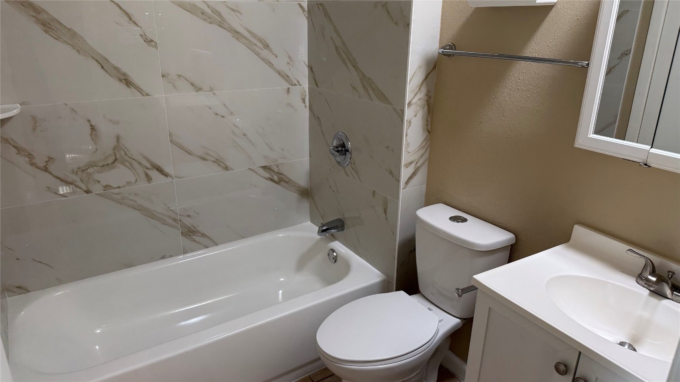 10400 Burmaster Lane, Unit A Austin, TX 78750 - Photo 9 of 20 a white toilet sitting next to a bath tub