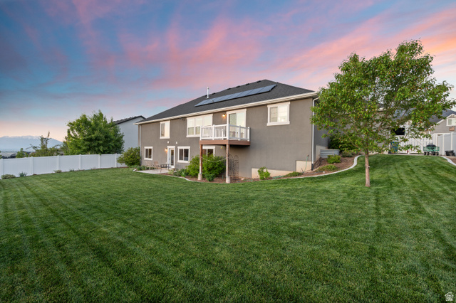 1145 North Christley Lane, Unit 48 Elk Ridge, UT 84651 - Photo 30 of 38 Expansive rear lawn with established tree and white vinyl fencing