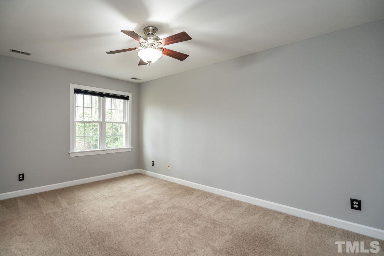 107 Needle Park Drive Cary, NC 27513 - Photo 14 of 29 an empty room with a window and a fan