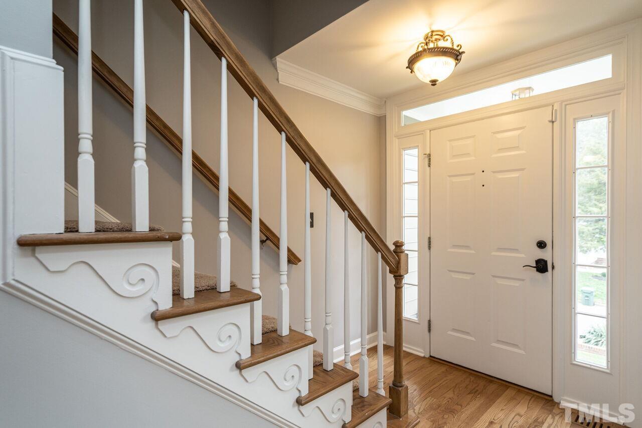 107 Needle Park Drive Cary, NC 27513 - Photo 2 of 29 a view of entryway and hall with wooden floor