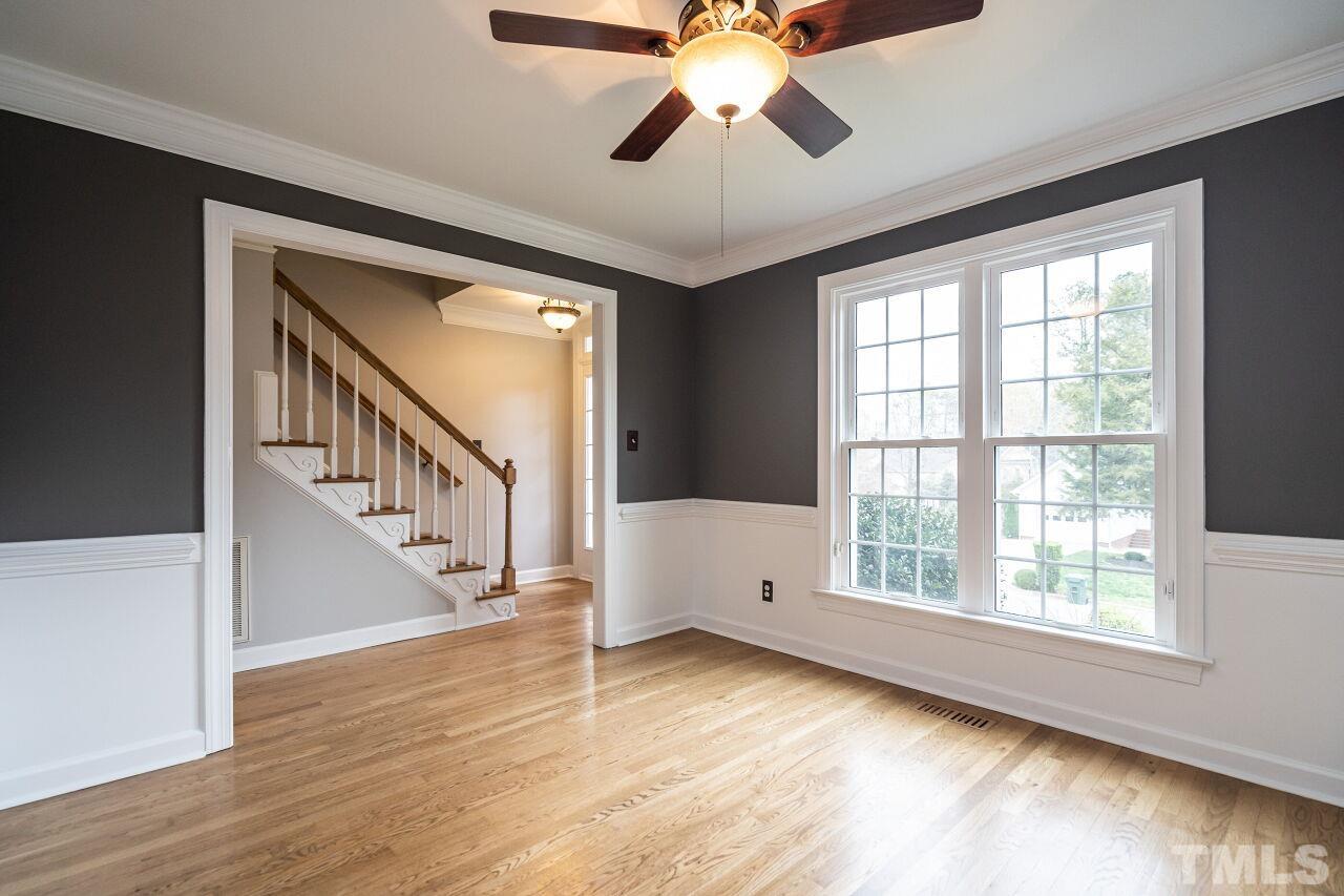 107 Needle Park Drive Cary, NC 27513 - Photo 3 of 29 a view of an empty room with wooden floor and chandelier