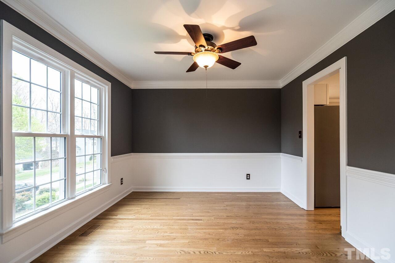 107 Needle Park Drive Cary, NC 27513 - Photo 4 of 29 a view of an empty room with wooden floor and a window