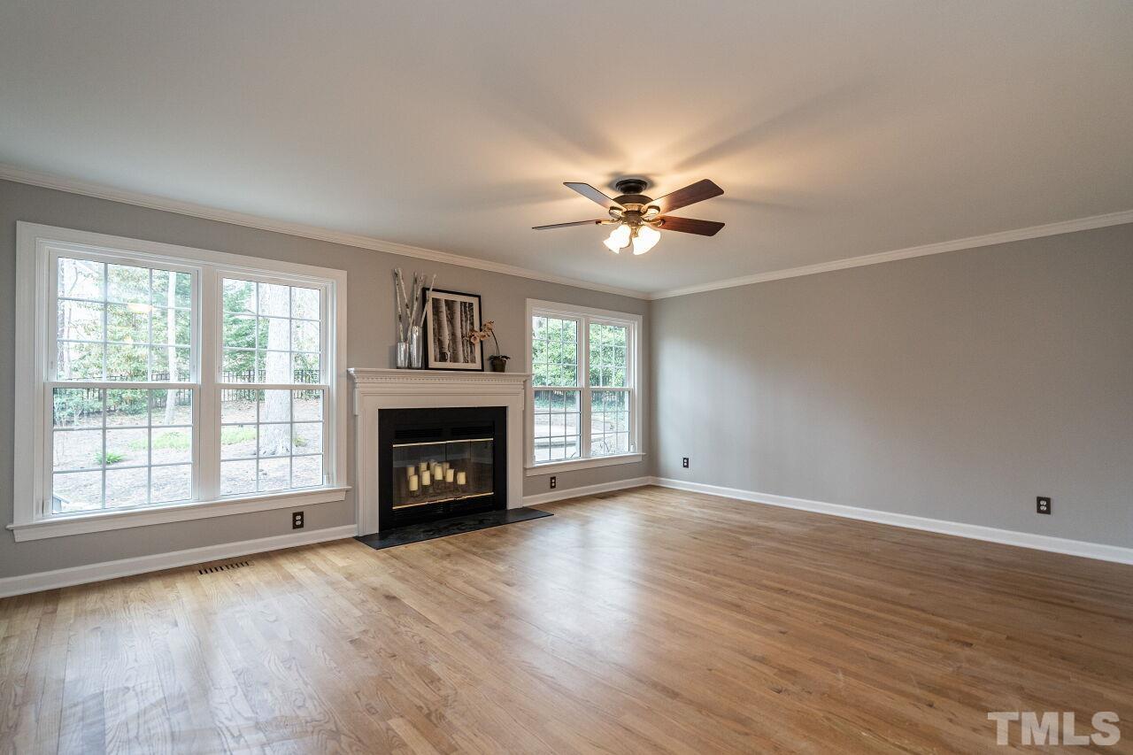 107 Needle Park Drive Cary, NC 27513 - Photo 6 of 29 an empty room with windows a fireplace