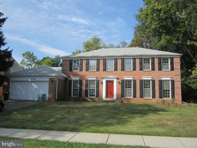10702 Gainsborough Road Potomac, MD 20854 - Photo 2 of 4 a front view of a house with a garden