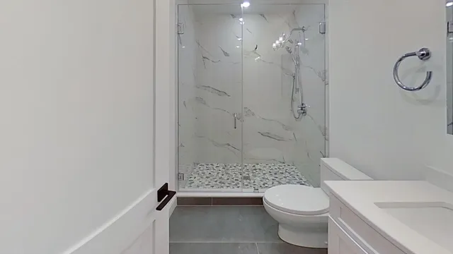a bathroom with a toilet sink and shower