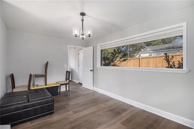 a view of a room with furniture wooden floor and windows