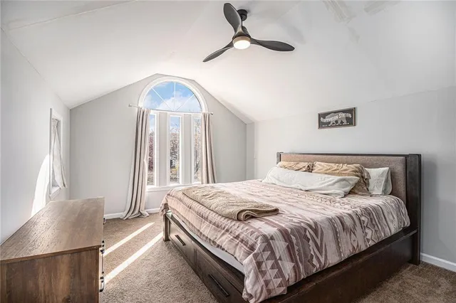 a bedroom with a bed a window and couch