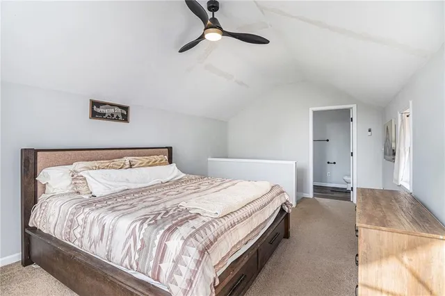 a bedroom with a bed and a ceiling fan
