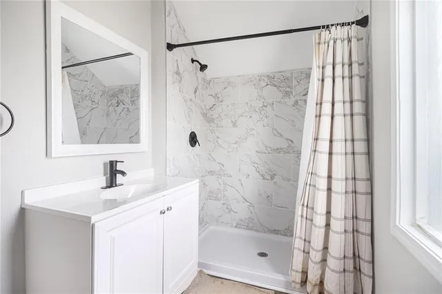 a bathroom with a shower and a sink