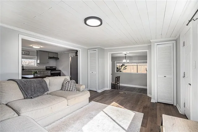 a living room with furniture and a view of bedroom