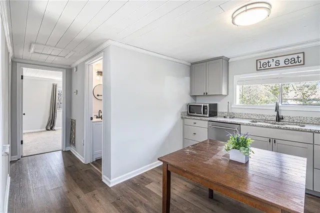 a kitchen with a wooden floor window and cabinets