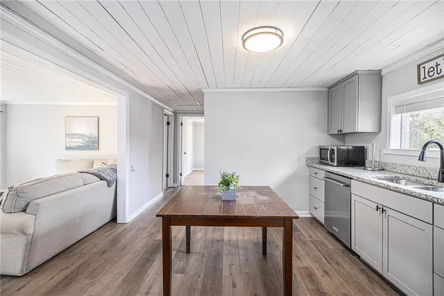 a kitchen with a table chairs sink and cabinets