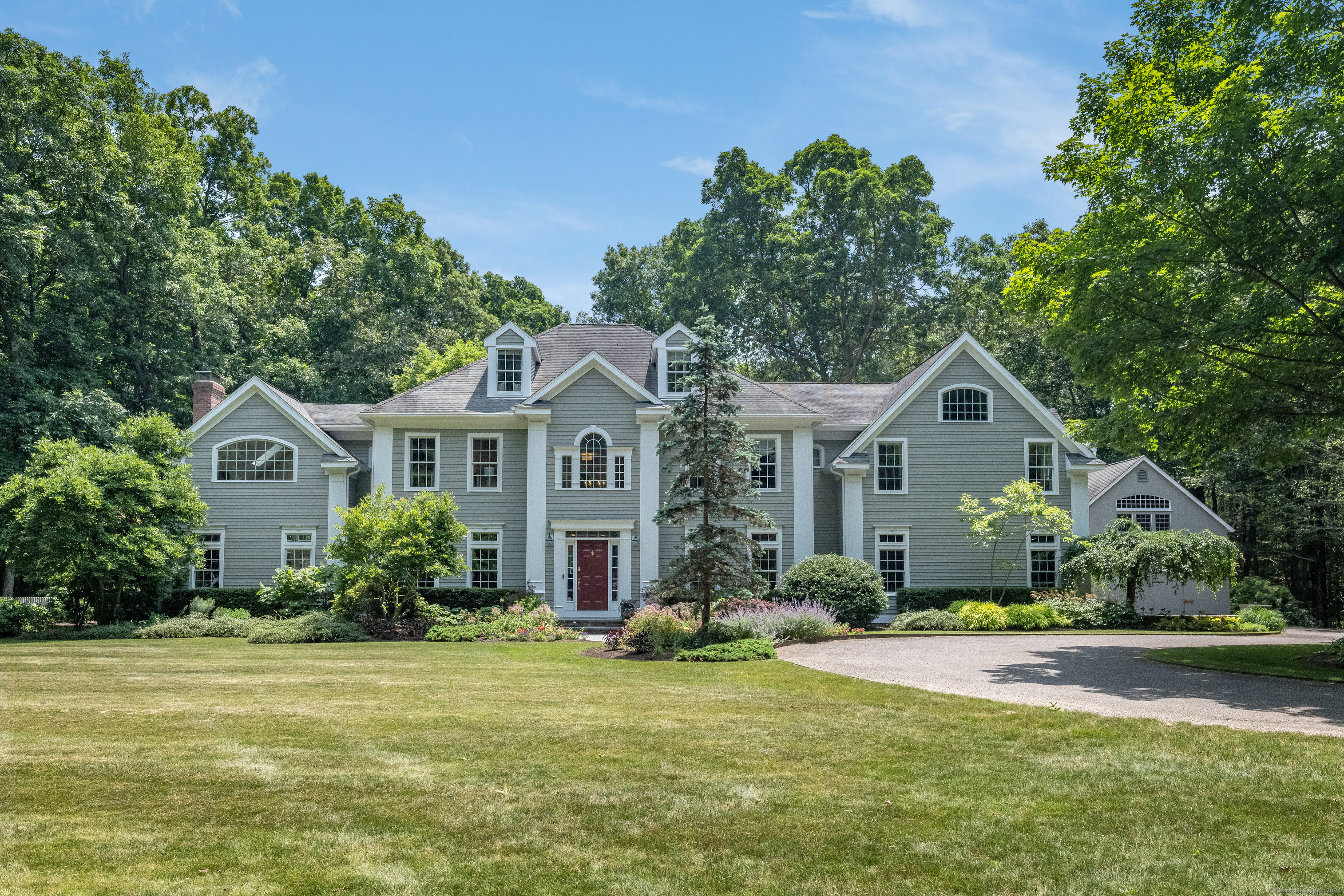 58 Indigo Trail Madison, CT 06443 - Photo 1 of 1 a front view of a house with a yard and garage