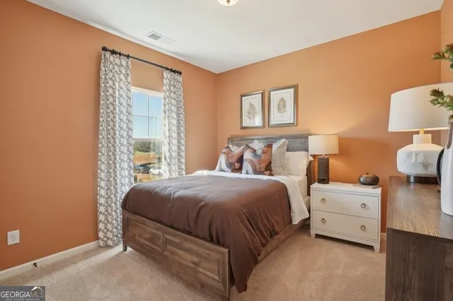 a bedroom with a bed and a night stand