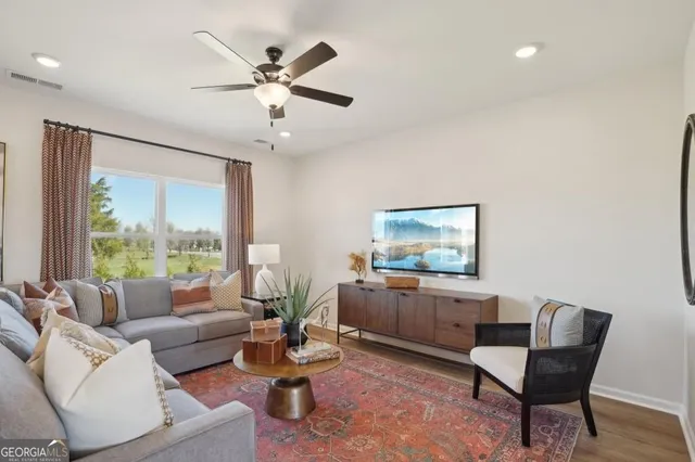 a living room with furniture and a large window