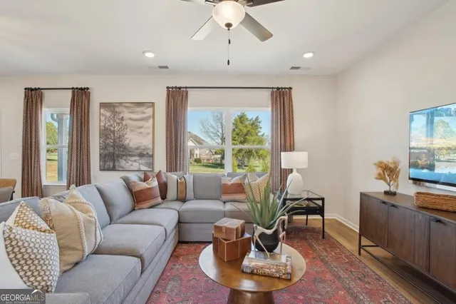 a living room with furniture and a large window