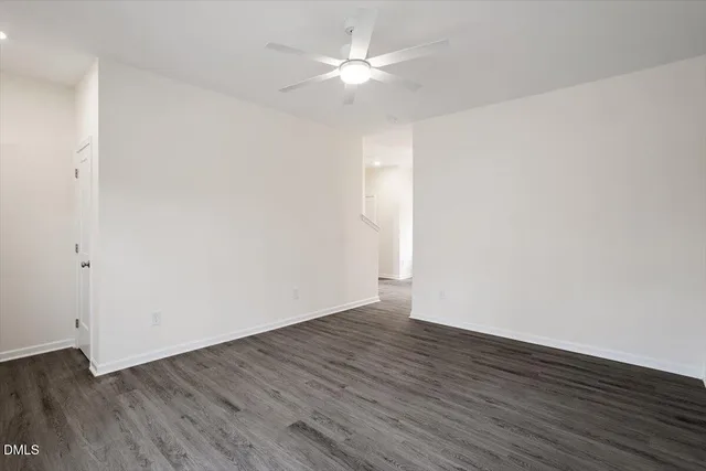 a kitchen with granite countertop wooden floors stainless steel appliances and sink