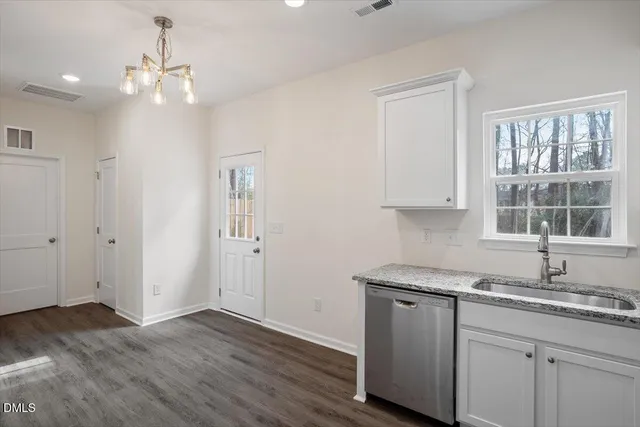 a bathroom with a granite countertop sink a toilet and a large mirror