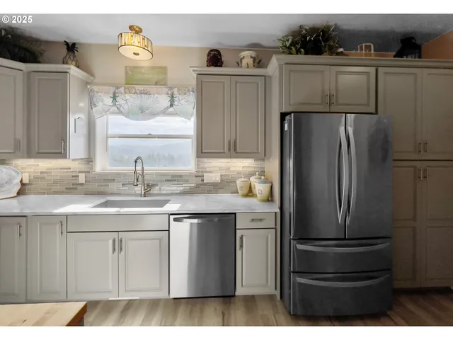 a kitchen with stainless steel appliances granite countertop a refrigerator and a sink