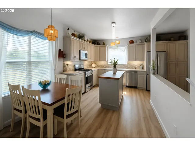 a dining room with furniture window and wooden floor