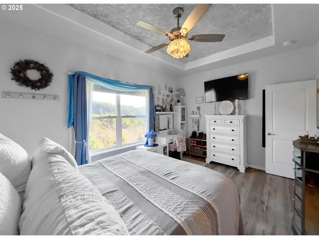 a bedroom with a bed and a television