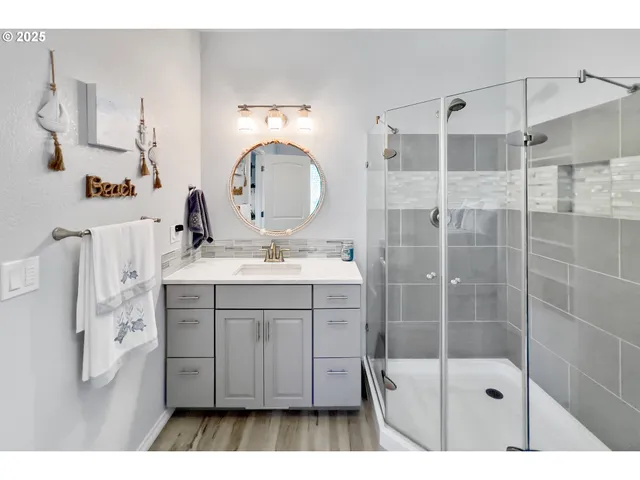 a bathroom with a sink mirror toilet and shower