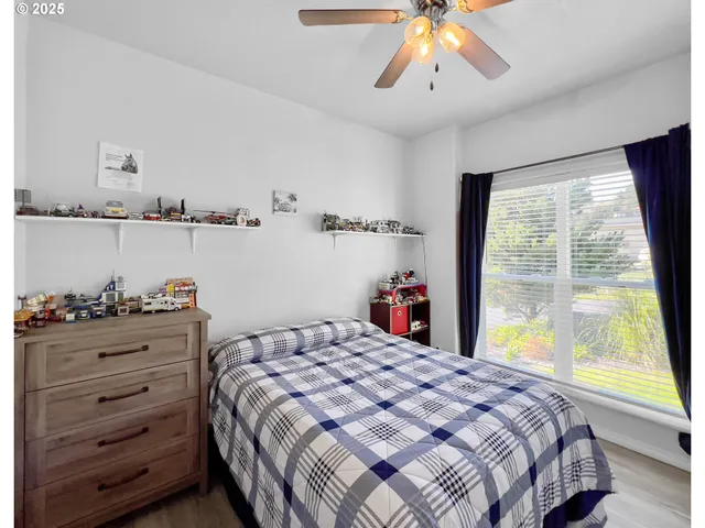 a bedroom with a large bed and a large window
