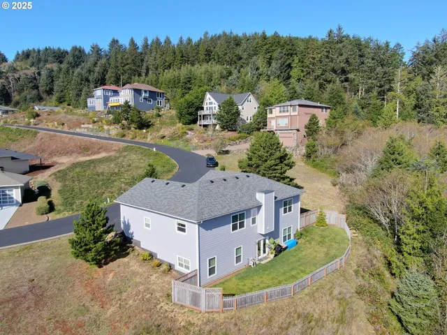 an aerial view of a house with yard swimming pool and mountain view