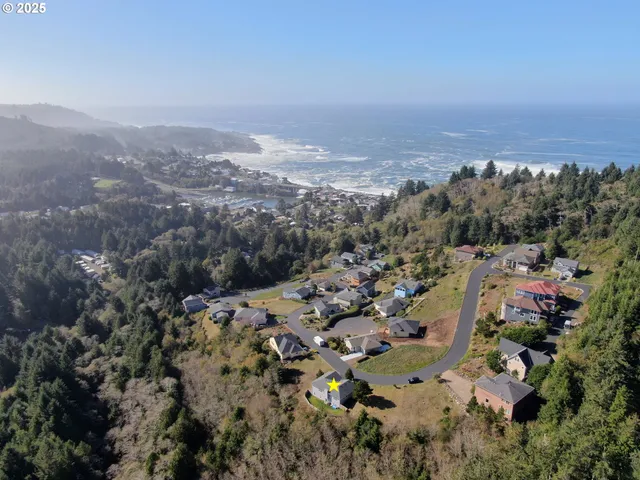 an aerial view of house with yard and mountain view in back