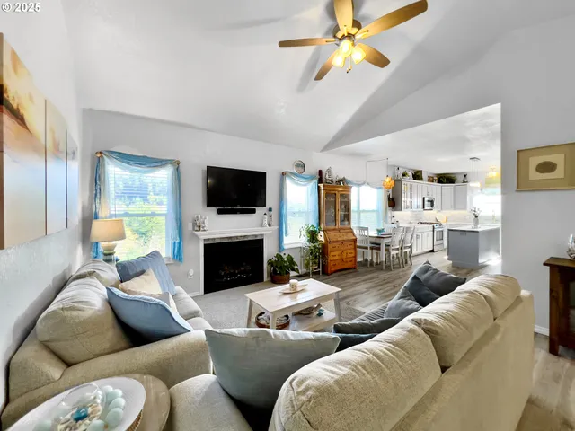a living room with furniture a fireplace and a flat screen tv