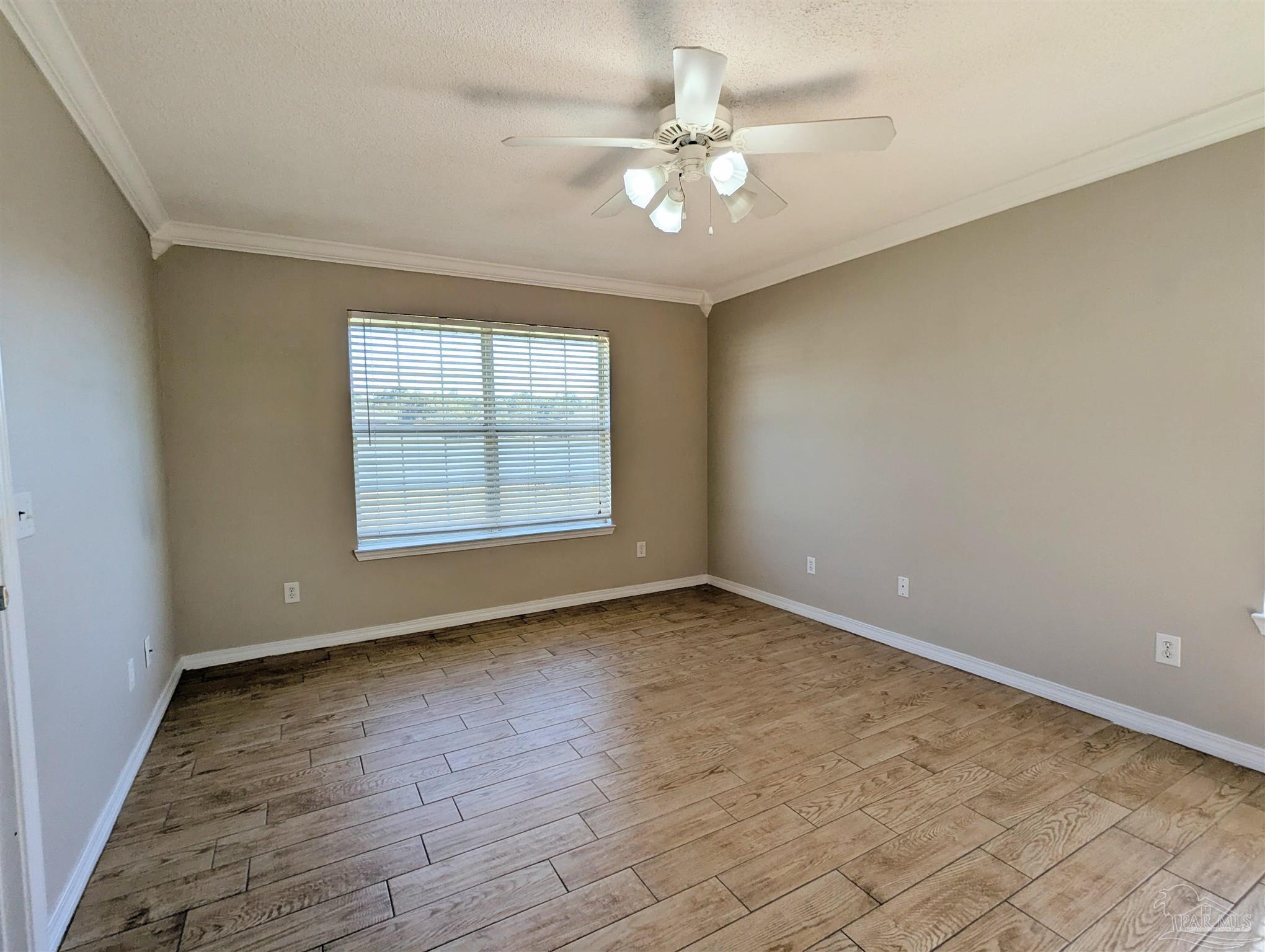 7108 Fitzpatrick Road Pensacola, FL 32526 - Photo 14 of 30 an empty room with wooden floor and windows