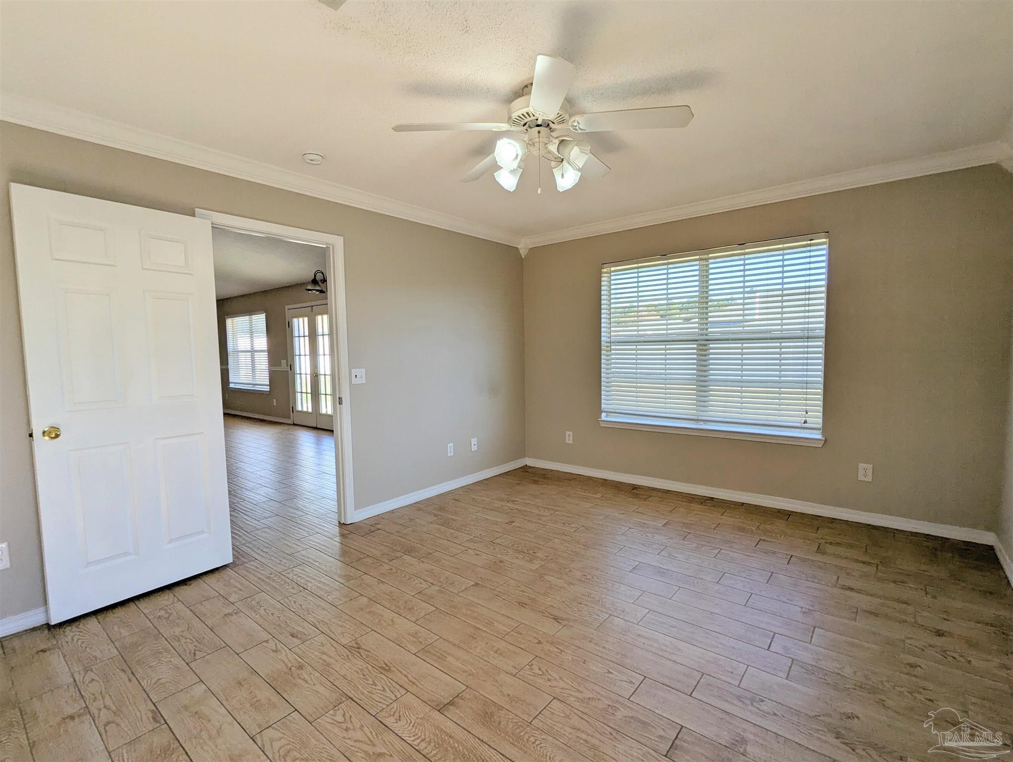 7108 Fitzpatrick Road Pensacola, FL 32526 - Photo 15 of 30 an empty room with wooden floor chandelier and windows