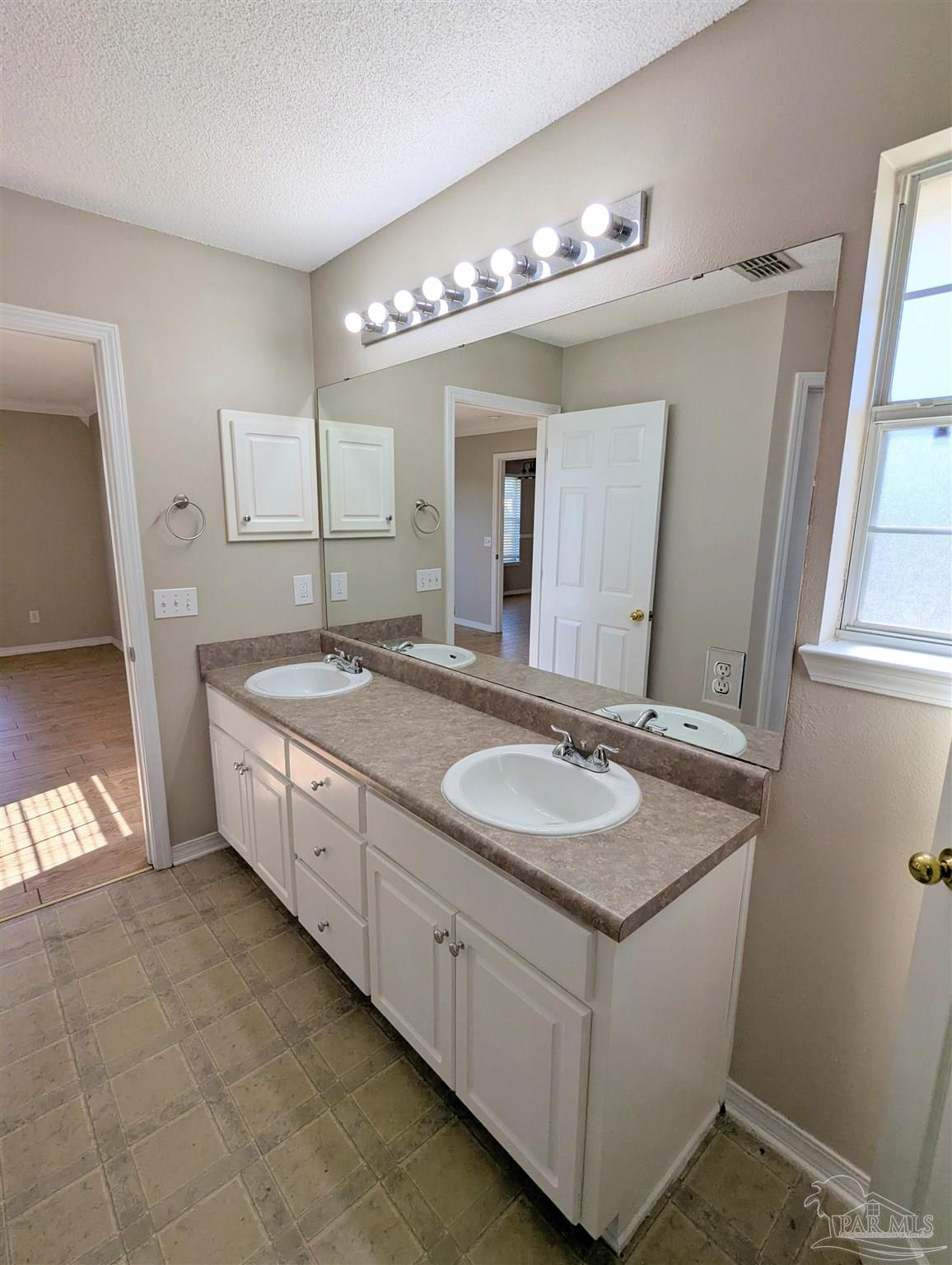 7108 Fitzpatrick Road Pensacola, FL 32526 - Photo 18 of 30 a bathroom with a granite countertop double vanity sink and a mirror