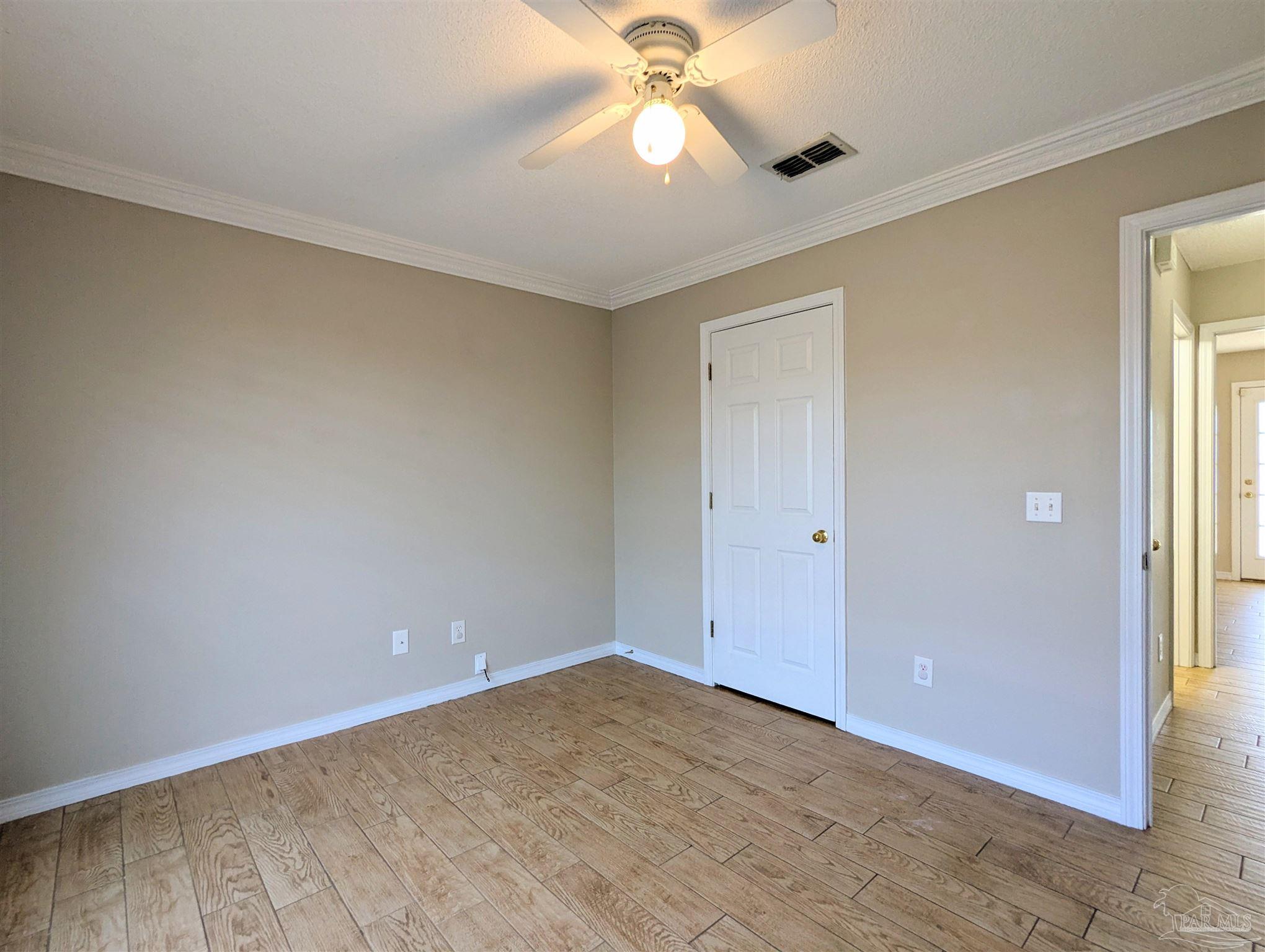 7108 Fitzpatrick Road Pensacola, FL 32526 - Photo 21 of 30 a view of an empty room and chandelier fan