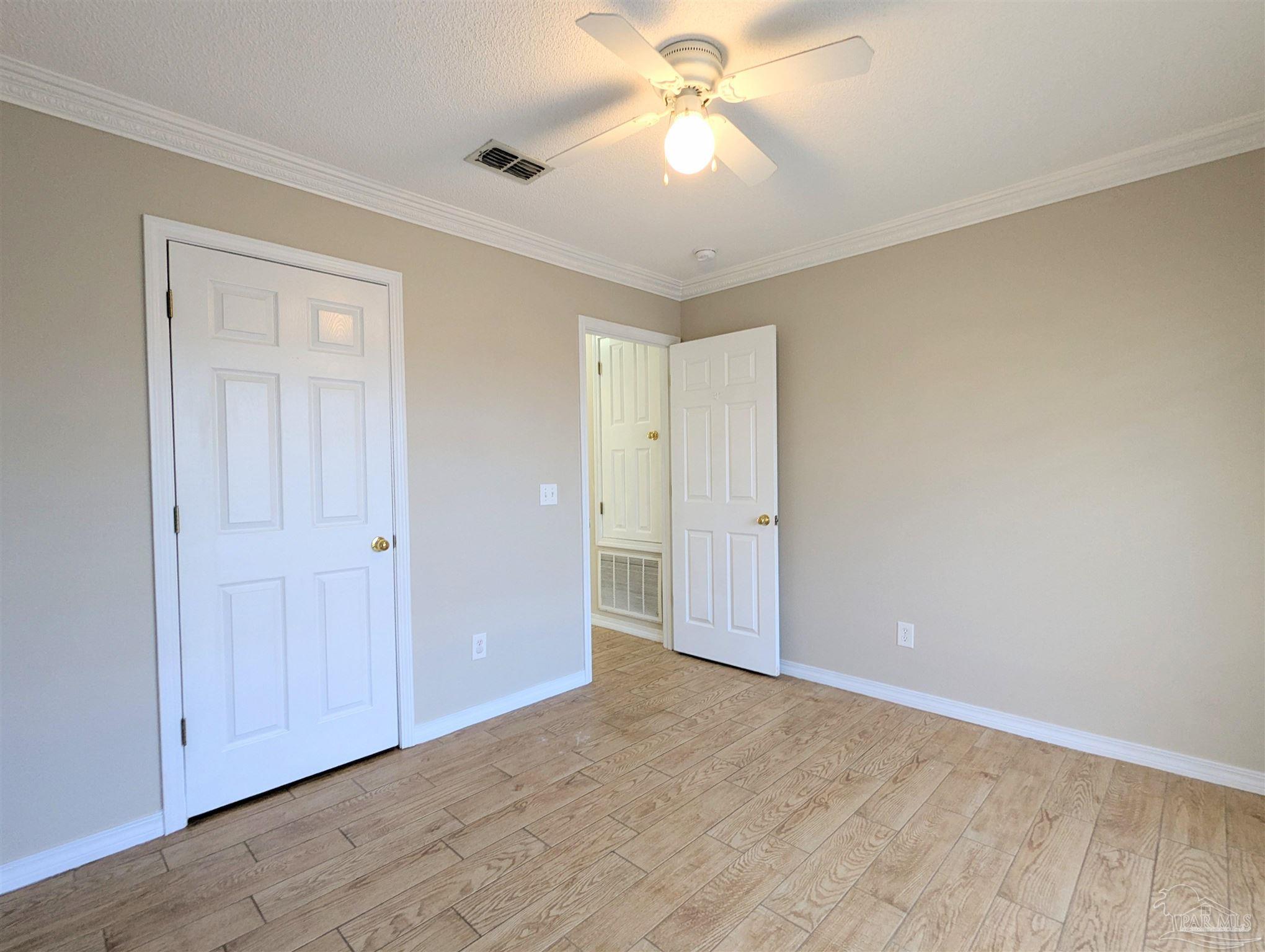7108 Fitzpatrick Road Pensacola, FL 32526 - Photo 22 of 30 a view of an empty room and chandelier fan