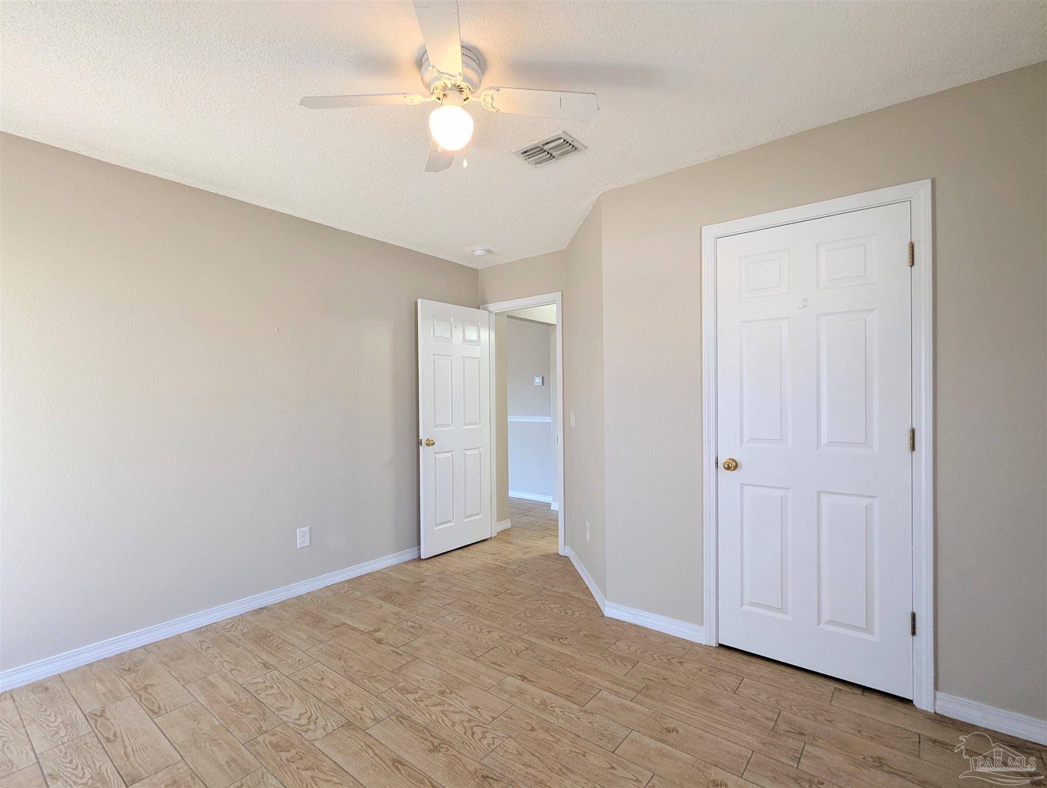 7108 Fitzpatrick Road Pensacola, FL 32526 - Photo 25 of 30 a view of an empty room and a ceiling fan