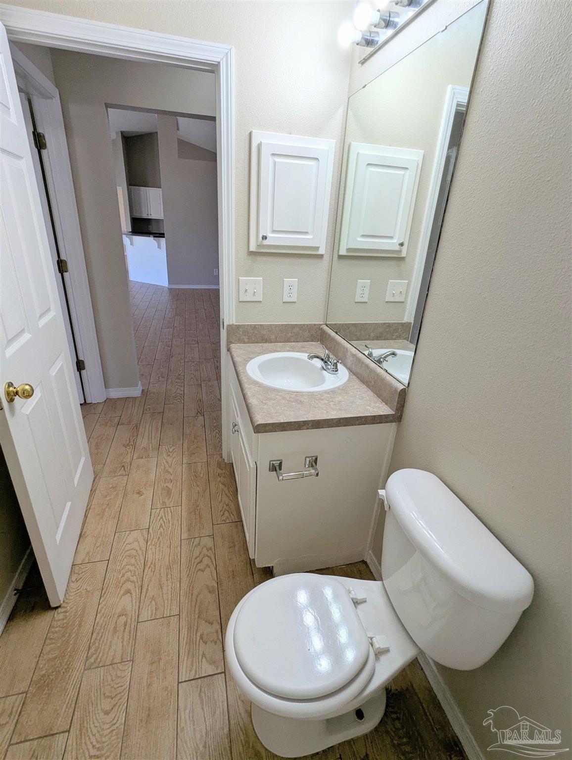 7108 Fitzpatrick Road Pensacola, FL 32526 - Photo 28 of 30 a white toilet sitting next to a bathroom sink
