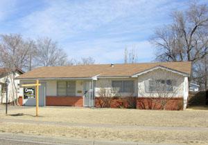 2913 Ricks Street Amarillo, TX 79103 - Photo 1 of 1 a view of a white house with a large windows and a yard with plants and large trees
