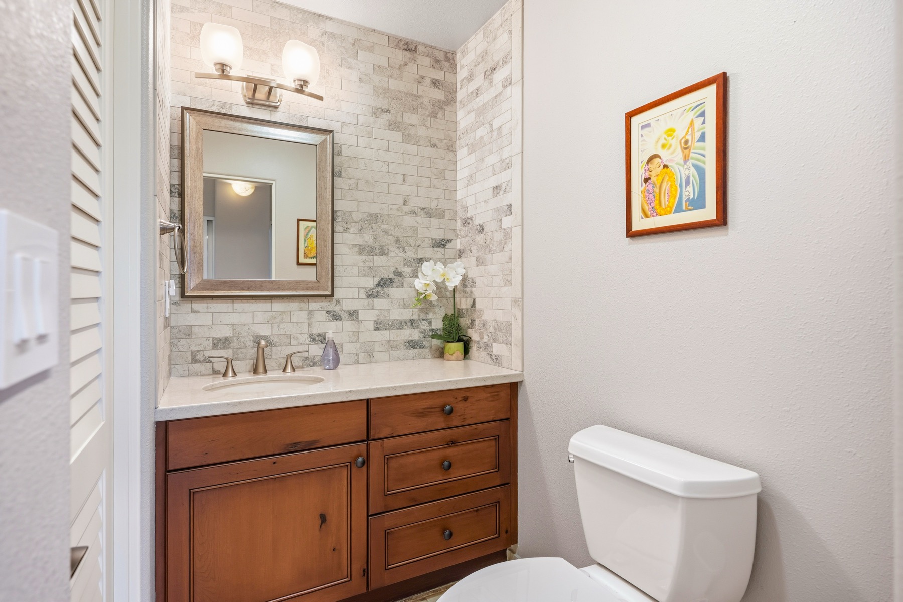 3564 Kaweonui Road Princeville, HI 96722 - Photo 22 of 30 a bathroom with a toilet sink and mirror