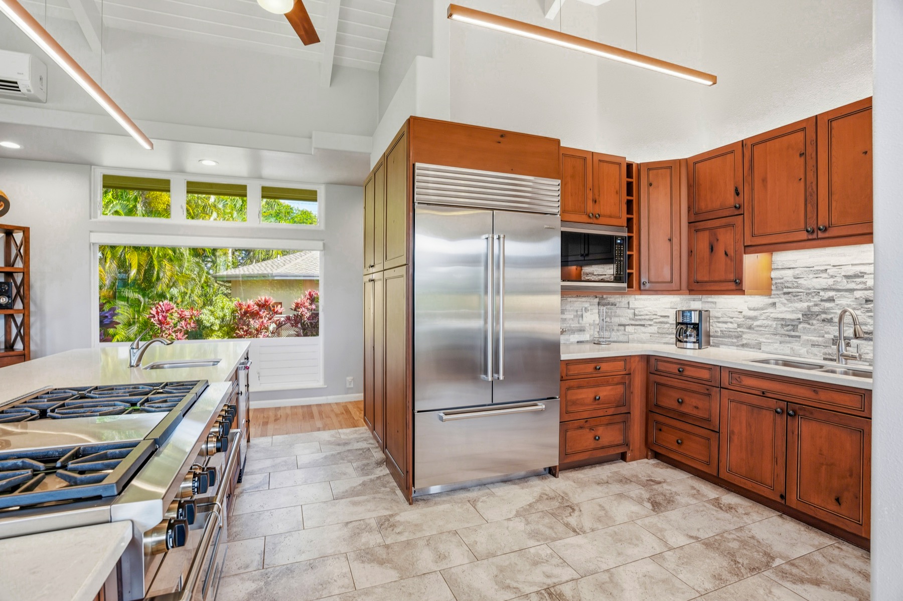3564 Kaweonui Road Princeville, HI 96722 - Photo 4 of 30 a kitchen with stainless steel appliances granite countertop a refrigerator and a sink