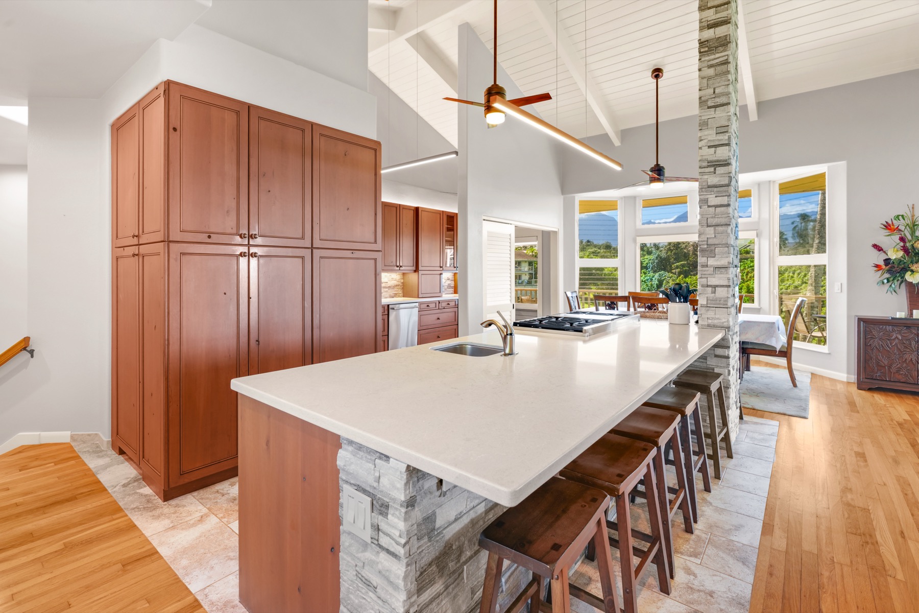 3564 Kaweonui Road Princeville, HI 96722 - Photo 5 of 30 a dining table with chairs and wooden floor