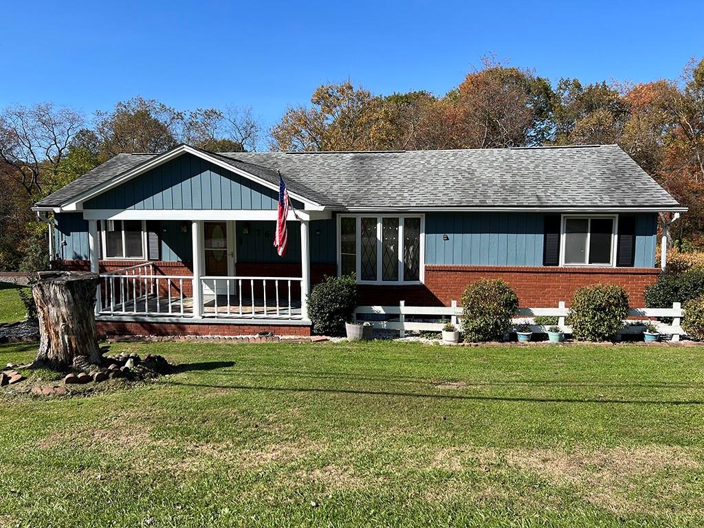 76 Cherry Run Road Homer City, PA 15748 - Photo 1 of 20 a front view of a house with a yard table and chairs
