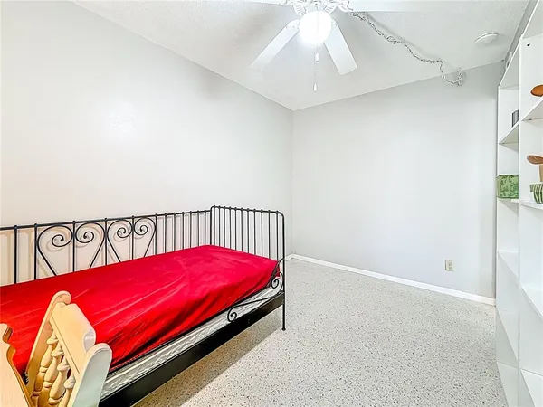 a bed sitting in a bedroom next to a window