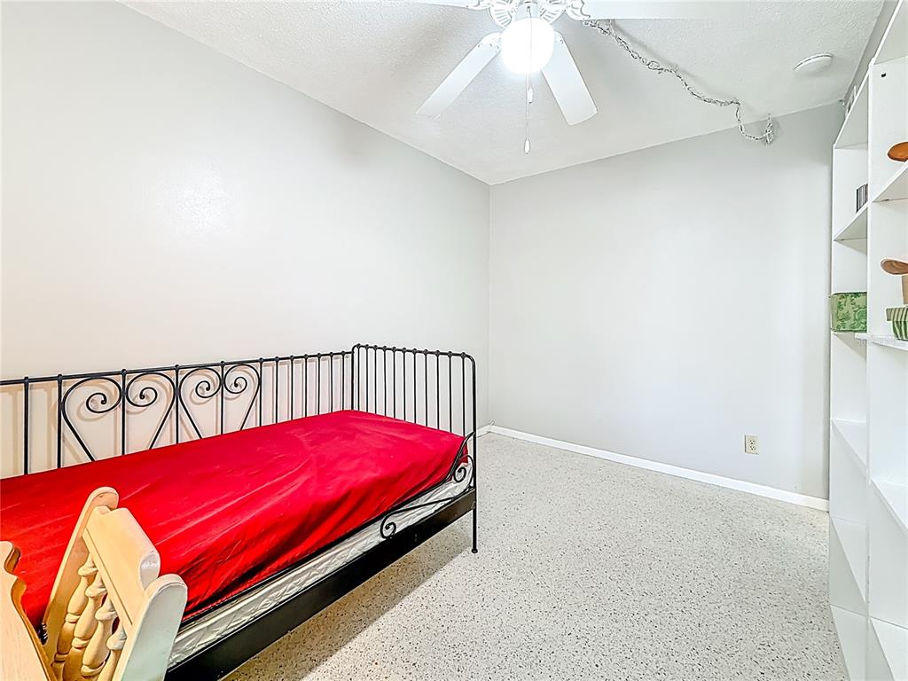 250 Rosery Road Northwest, Unit 283 Largo, FL 33770 - Photo 12 of 23 a bed sitting in a bedroom next to a window