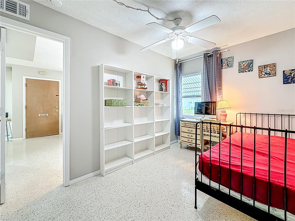 250 Rosery Road Northwest, Unit 283 Largo, FL 33770 - Photo 13 of 23 a view of a hallway with a bedroom and a window