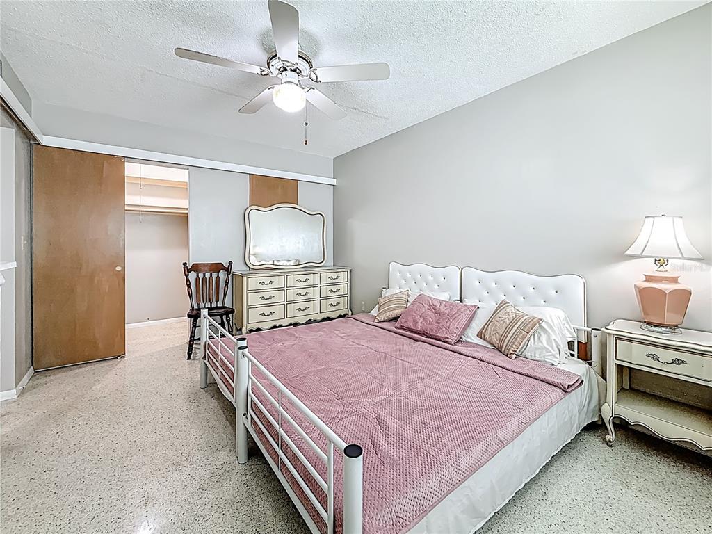 250 Rosery Road Northwest, Unit 283 Largo, FL 33770 - Photo 14 of 23 a bedroom with a bed and a chandelier